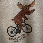 Maine Moose Riding a Bicycle – Crop Sweatshirt